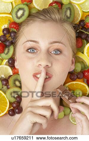 Portrait Of Young Woman Eating Chocolate View Large Photo Image Stock Image - Portrait Of Young Woman Eating Chocolate. Fotosearch