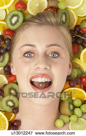 Stock Photo - Portrait Of Young Woman Eating Chocolate. Fotosearch