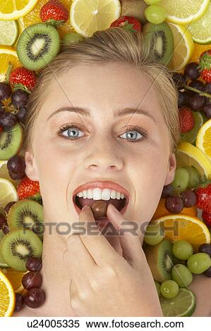 Portrait Of Young Woman Eating Chocolate View Large Photo Image Stock Photography - Portrait Of Young Woman Eating Chocolate. Fotosearch
