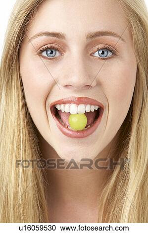 Portrait Of Young Woman Eating Grape View Large Photo Image Stock Image - Portrait Of Young Woman Eating Grape. Fotosearch