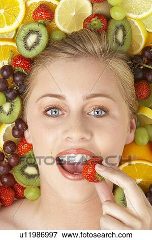 Portrait Of Young Woman Eating Strawberry View Large Photo Image Stock Photo - Portrait Of Young Woman Eating Strawberry. Fotosearch