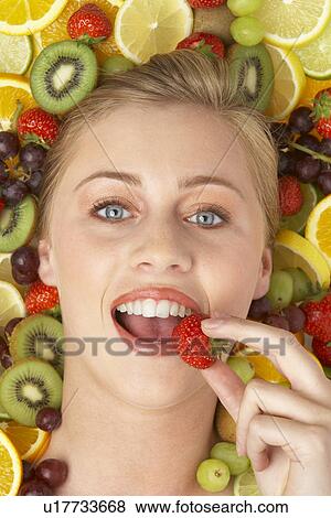 Portrait Of Young Woman Eating Strawberry View Large Photo Image Stock Photo - Portrait Of Young Woman Eating Strawberry. Fotosearch