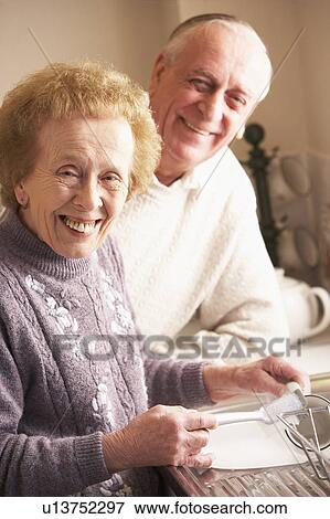 Stock Photo - Senior Couple Washing Up At Sink. Fotosearch