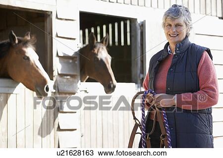 Senior Woman Standing By Stables View Large Photo Image Stock Image - Senior Woman Standing By Stables. Fotosearch