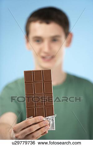 Teenage Boy Holding Bar Of Chocolate View Large Photo Image Stock Photograph - Teenage Boy Holding Bar Of Chocolate. Fotosearch