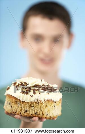 Stock Photo - Teenage Boy Holding Cream Cake. Fotosearch