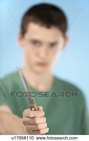 Stock Image - Teenage Boy Holding Knife . Fotosearch