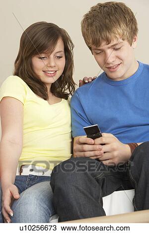 Teenage Couple Reading Text Message View Large Photo Image Stock Image - Teenage Couple Reading Text Message. Fotosearch