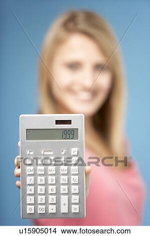 Picture - Teenage Girl Holding Calculator. Fotosearch