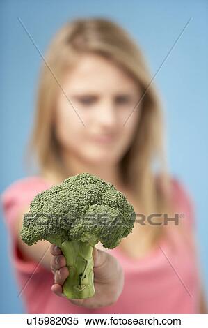 Stock Photography - Teenage Girl Holding Fresh Broccoli. Fotosearch