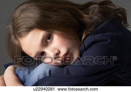 Stock Image - Thoughtful Girl Sitting In Studio. Fotosearch