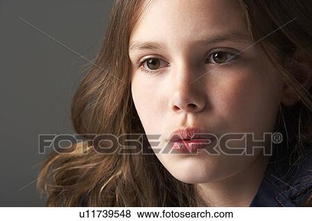 Stock Photo - Thoughtful Girl Sitting In Studio. Fotosearch