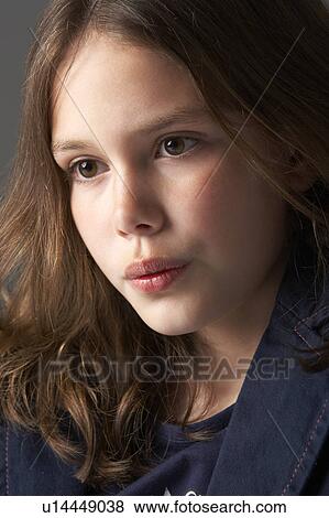 Stock Photo - Thoughtful Girl Sitting In Studio. Fotosearch