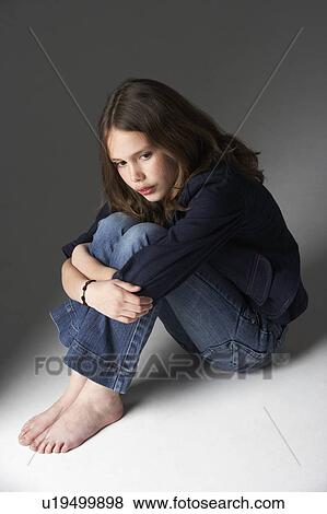 Thoughtful Girl Sitting In Studio View Large Photo Image Stock Photo - Thoughtful Girl Sitting In Studio. Fotosearch