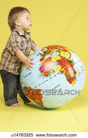 Stock Photography - Toddler In Studio With Globe. Fotosearch