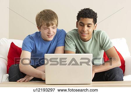Two Boys Using Laptop At Home View Large Photo Image Stock Photo - Two Boys Using Laptop At Home. Fotosearch