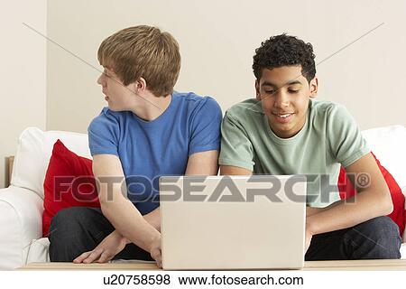 Two Boys Using Laptop At Home View Large Photo Image Stock Photo - Two Boys Using Laptop At Home. Fotosearch