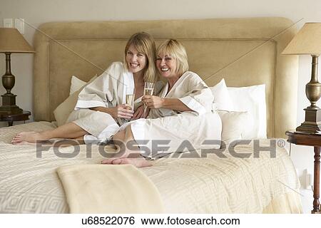 Two Women Enjoying Champagne In Bedroom View Large Photo Image Stock Photograph - Two Women Enjoying Champagne In Bedroom. Fotosearch