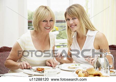 Stock Image - Two Women Enjoying Hotel Breakfast. Fotosearch