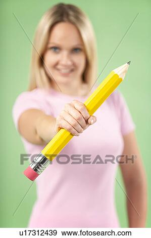 Stock Photo - Woman Holding Big Pencil. Fotosearch