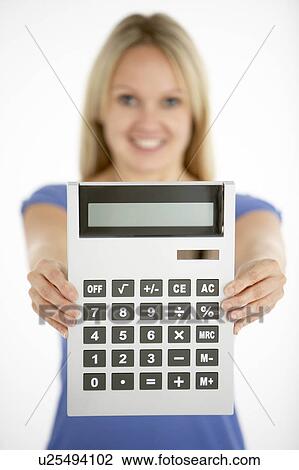 Stock Image - Woman Holding Calculator. Fotosearch