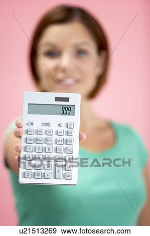 Stock Photo - Woman Holding Calculator. Fotosearch
