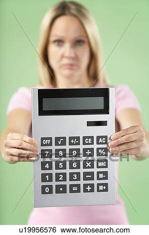 Stock Photograph - Woman Holding Calculator. Fotosearch