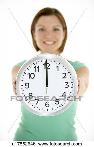 Woman Holding Clock Showing 12 O'Clock View Large Photo Image Stock Photograph - Woman Holding Clock Showing 12 O'Clock. Fotosearch