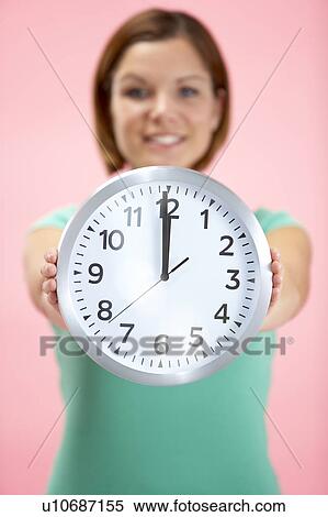 Woman Holding Clock Showing 12 O'Clock View Large Photo Image Stock Photography - Woman Holding Clock Showing 12 O'Clock. Fotosearch