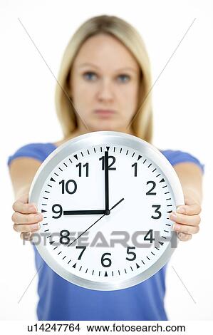 Woman Holding Clock Showing 9 O'Clock View Large Photo Image Picture - Woman Holding Clock Showing 9 O'Clock. Fotosearch
