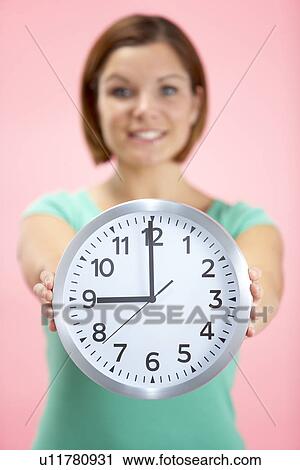 Woman Holding Clock Showing 9 O'Clock View Large Photo Image Stock Image - Woman Holding Clock Showing 9 O'Clock. Fotosearch