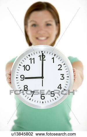 Woman Holding Clock Showing 9 O'Clock View Large Photo Image Stock Image - Woman Holding Clock Showing 9 O'Clock. Fotosearch