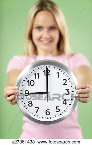 Woman Holding Clock Showing 9 O'Clock View Large Photo Image Stock Photo - Woman Holding Clock Showing 9 O'Clock. Fotosearch
