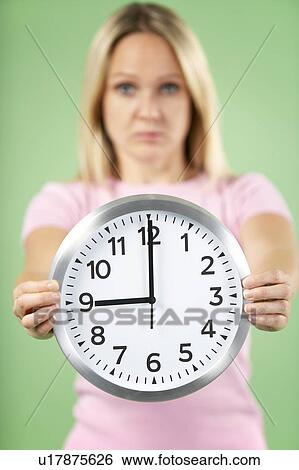 Woman Holding Clock Showing 9 O'Clock View Large Photo Image Stock Photograph - Woman Holding Clock Showing 9 O'Clock. Fotosearch