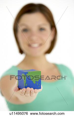 Stock Photograph - Woman Holding Cube Shaped Globe. Fotosearch