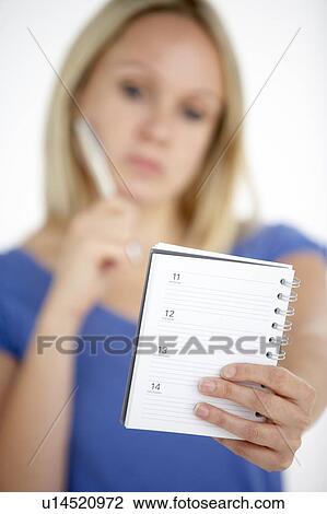 Stock Image - Woman Holding Diary. Fotosearch