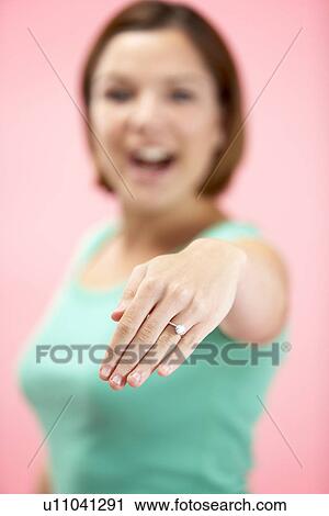 Stock Image - Woman Holding Engagement Ring. Fotosearch
