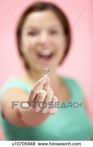 Stock Photo - Woman Holding Engagement Ring. Fotosearch