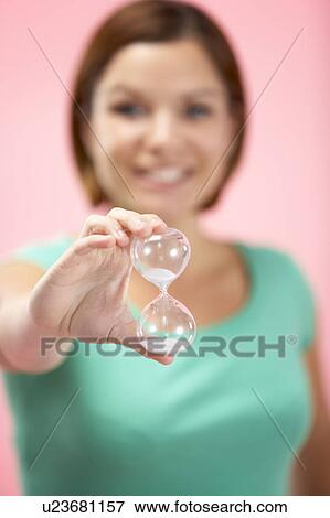 Stock Photo - Woman Holding Hourglass. Fotosearch