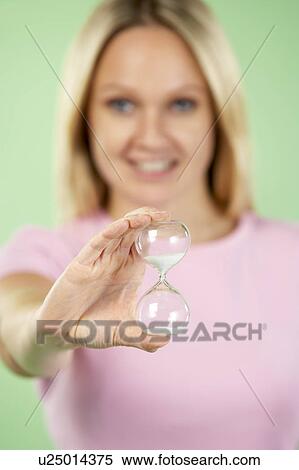 Stock Photography - Woman Holding Hourglass. Fotosearch