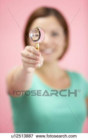 Stock Photo - Woman Holding Magnifying Glass. Fotosearch