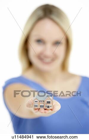 Stock Image - Woman Holding Model House. Fotosearch