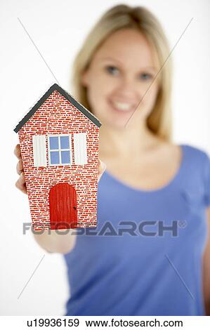 Stock Photo - Woman Holding Model House. Fotosearch