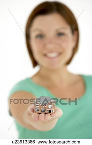 Stock Photograph - Woman Holding Model House. Fotosearch