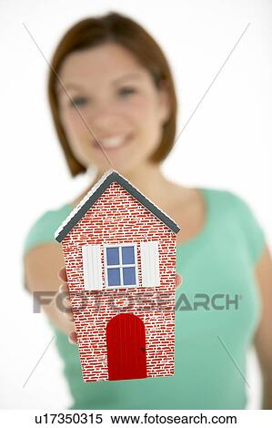 Stock Photography - Woman Holding Model House. Fotosearch