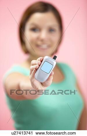 Stock Image - Woman Holding Model Mobile Phone. Fotosearch
