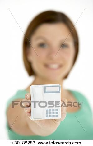 Stock Image - Woman Holding Model Telephone. Fotosearch