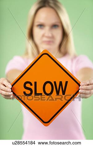 Picture - Woman Holding Road Traffic Sign. Fotosearch