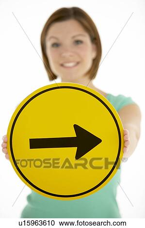 Stock Image - Woman Holding Road Traffic Sign. Fotosearch