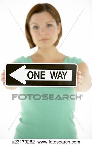 Stock Image - Woman Holding Road Traffic Sign. Fotosearch